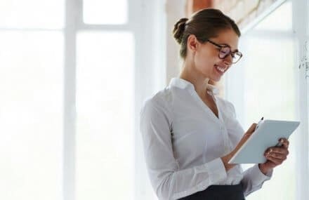 Professora em sala de aula em frente a quadro branco - vantagens de fazer um curso técnico presencial