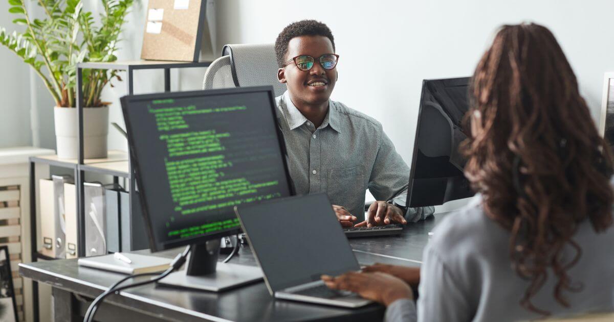 Jovens programadores no escritório da empresa - Vantagens para quem escolhe seguir carreira na área de Tecnologia da Informação
